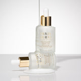Olivia Quido Skincare Niacinamide bottle sitting on another bottle in environment as part of the Skin Refining set