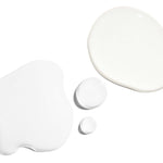 Skin Refining Set white lotion drops showcasing smooth textures for radiant skin.