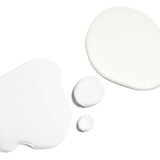 Skin Refining Set white lotion drops showcasing smooth textures for radiant skin.